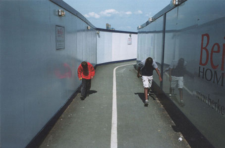 Photo of two figures in a passageway